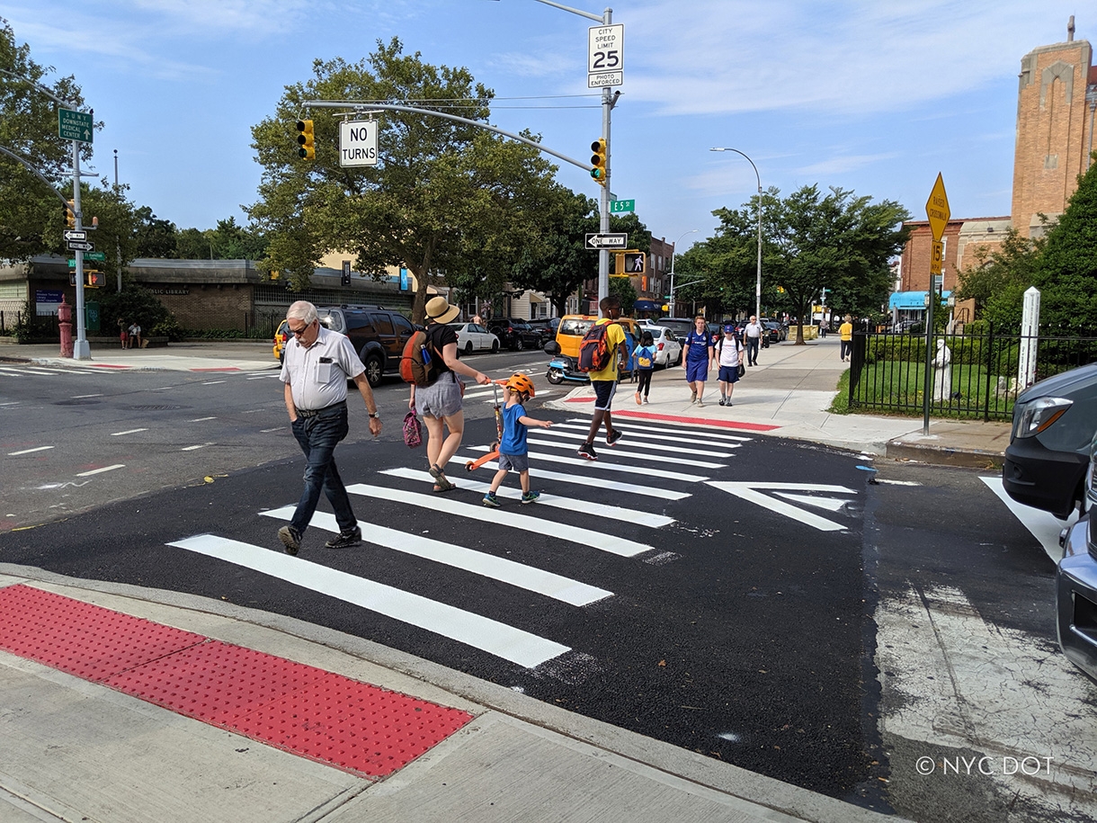 Couple with stroller crossing the street